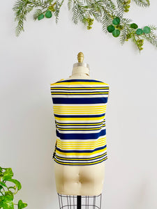 back side of a 1960s yellow and blue striped top with side square buttons on mannequin