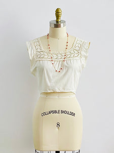 1910s Edwardian White Crochet Lace top on mannequin with beaded coral necklace