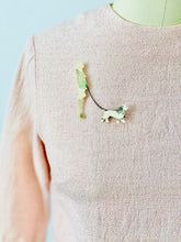 Load image into Gallery viewer, vintage 1920s flapper pin with dog on pink top
