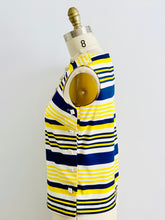 Load image into Gallery viewer, side view of a 1960s yellow and blue striped top with side square buttons on mannequin

